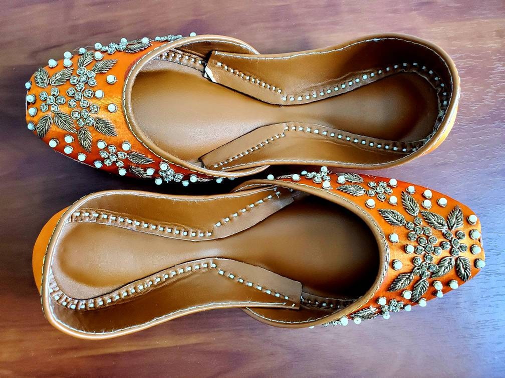 Orange khussa with heavy pearl and diamond work.