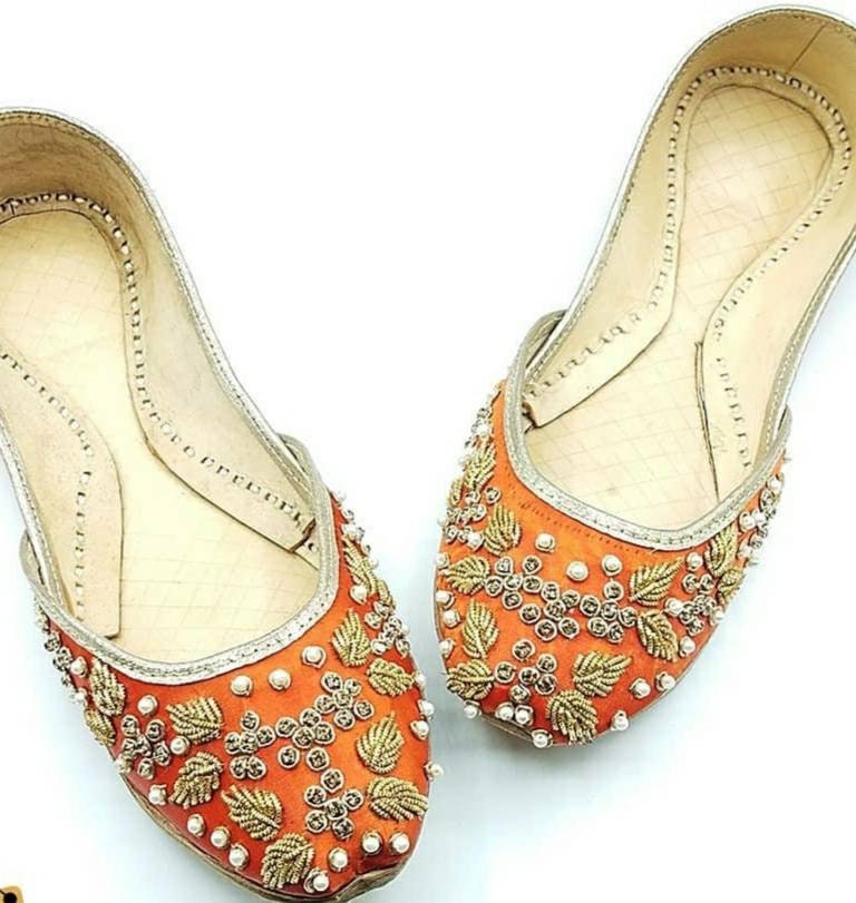 Orange khussa with heavy pearl and diamond work.