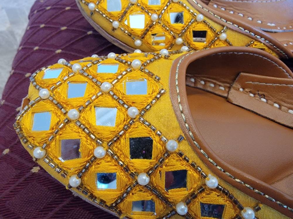 Featuring a stunning yellow mirror Embroidered khussa with detailed diamond placement of cut dana.