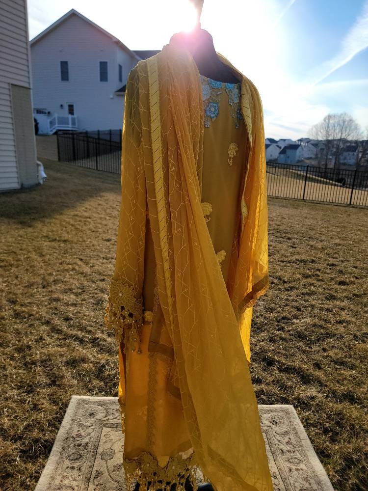 Beautiful yellow chikankari on pure chiffon.  Pakistani designer wear.