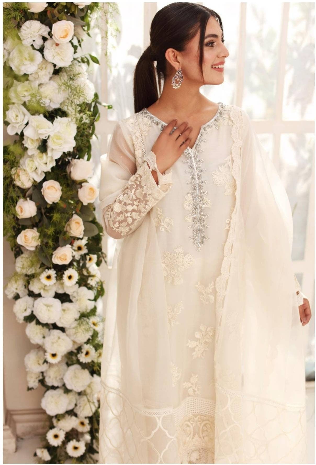 Gorgeous white cotton net shirt with handwork on gala. Pant and duppata included. Pakistani ready to wear formal attire. Agha noor.