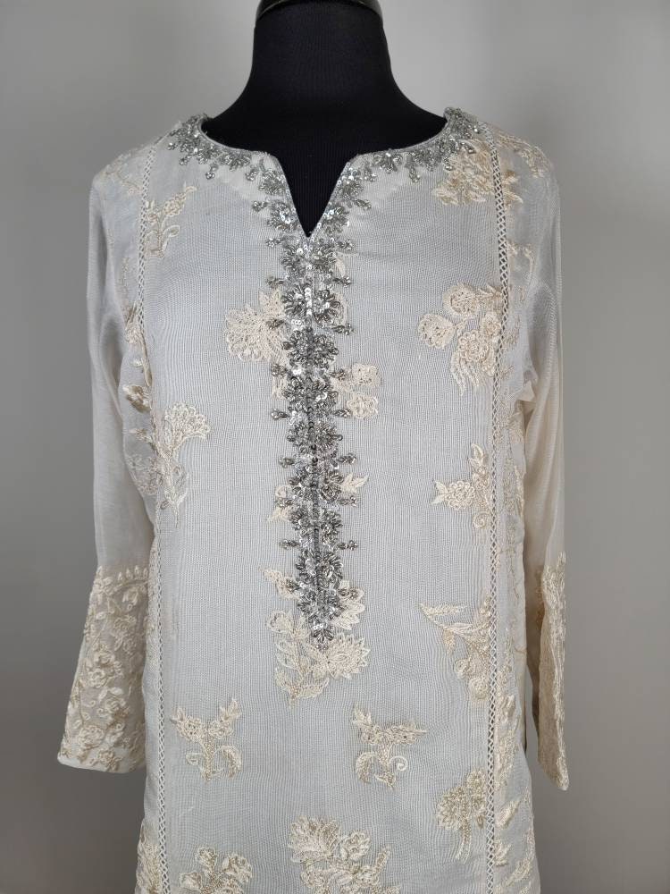 Gorgeous white cotton net shirt with handwork on gala. Pant and duppata included. Pakistani ready to wear formal attire. Agha noor.