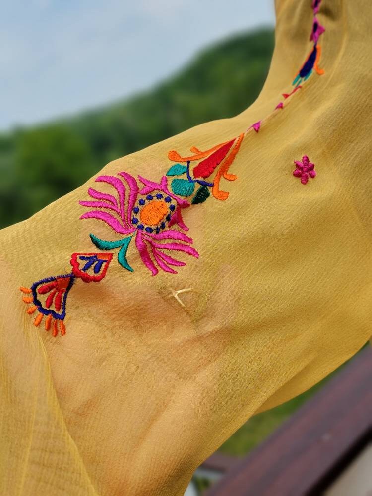 Yellow Embroidered multicolored frock. Size large.