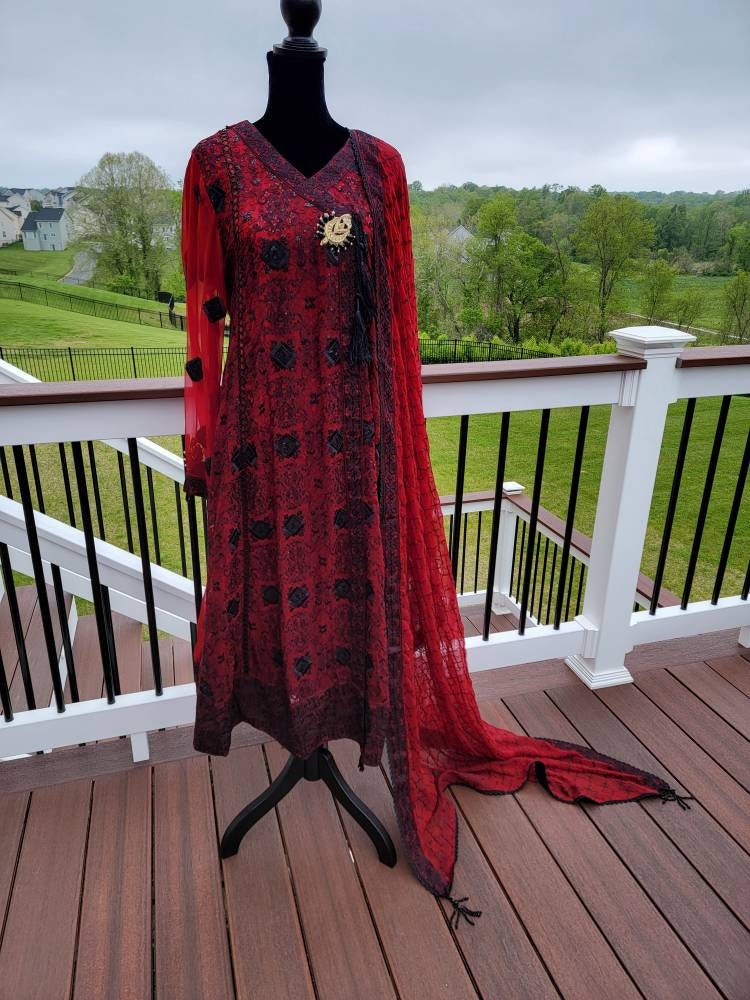 Deep red with black chikankari shirt. Paired with heavy Embroidered dupatta and silk trouser. Pakistani ready to wear.