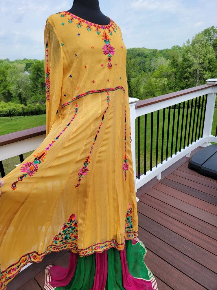 Yellow Embroidered multicolored frock. Size large.