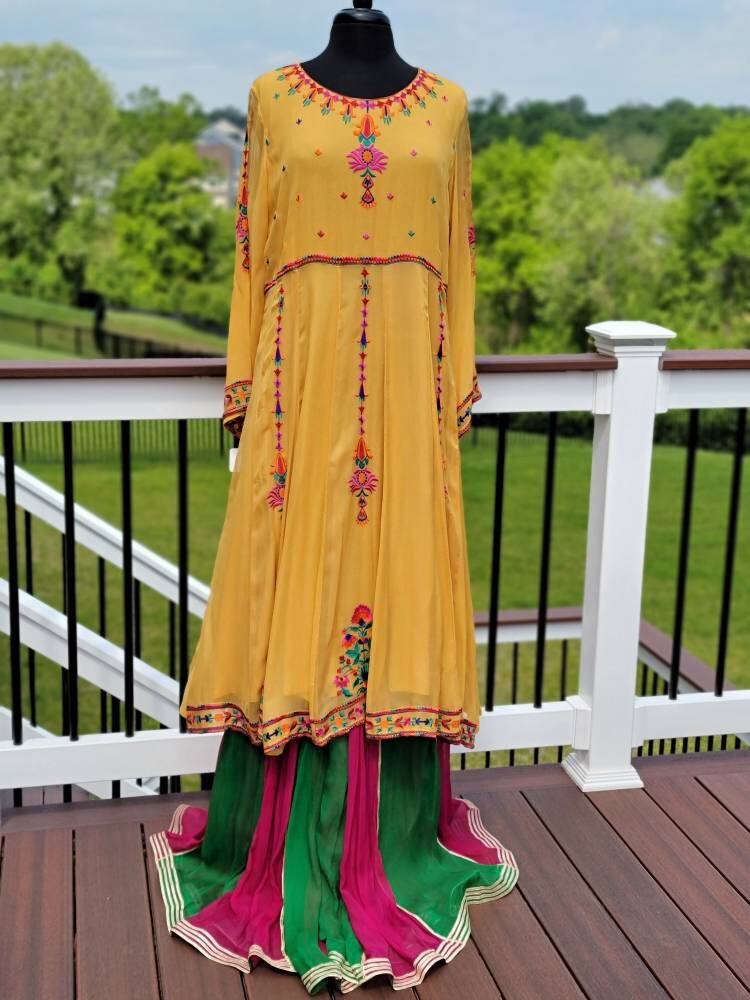 Yellow Embroidered multicolored frock. Size large.