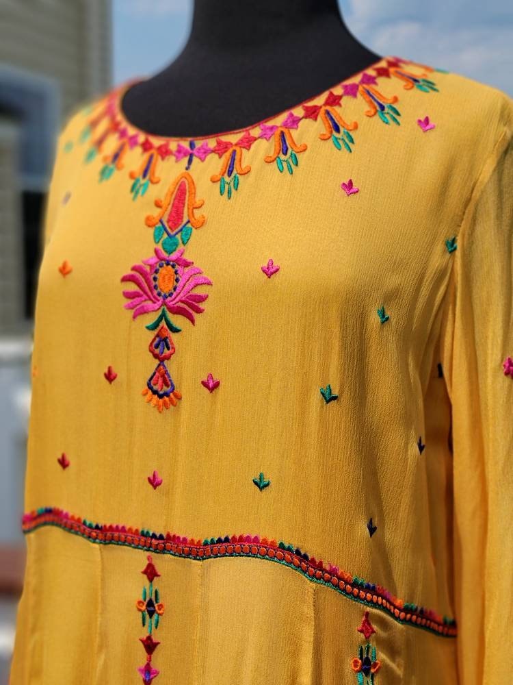 Yellow Embroidered multicolored frock. Size large.