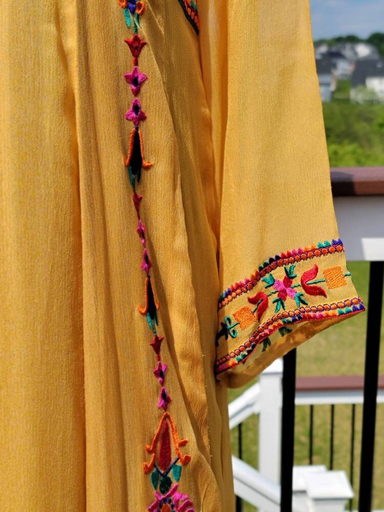 Yellow Embroidered multicolored frock. Size large.