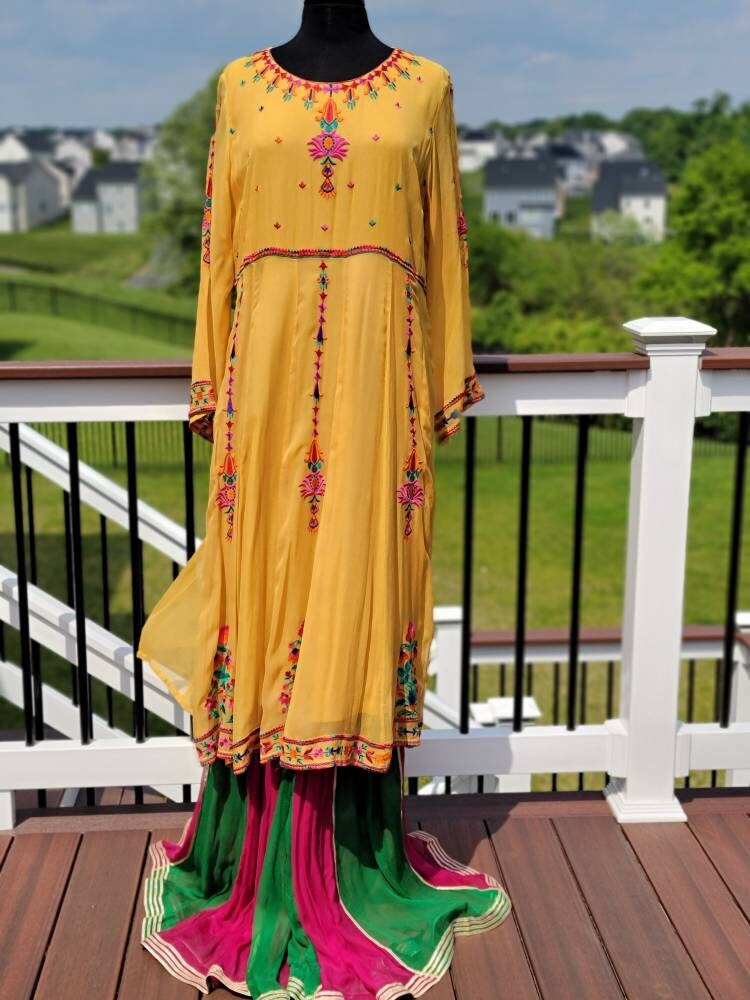 Yellow Embroidered multicolored frock. Size large.