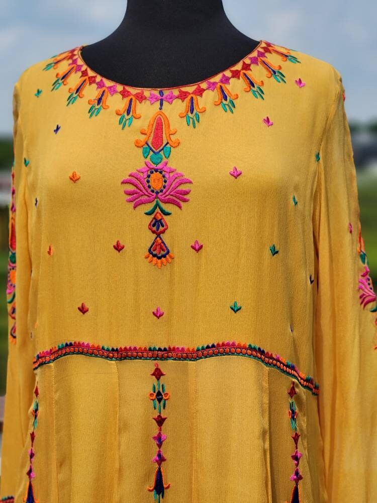 Yellow Embroidered multicolored frock. Size large.