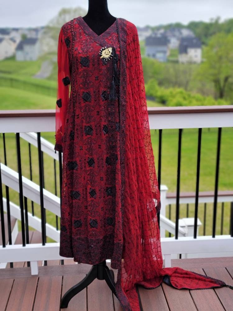 Deep red with black chikankari shirt. Paired with heavy Embroidered dupatta and silk trouser. Pakistani ready to wear.