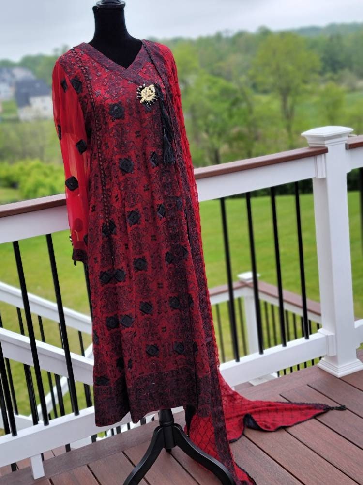 Deep red with black chikankari shirt. Paired with heavy Embroidered dupatta and silk trouser. Pakistani ready to wear.