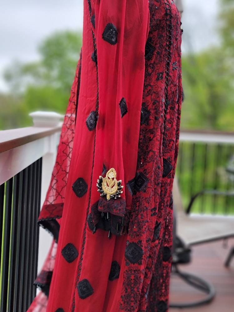 Deep red with black chikankari shirt. Paired with heavy Embroidered dupatta and silk trouser. Pakistani ready to wear.