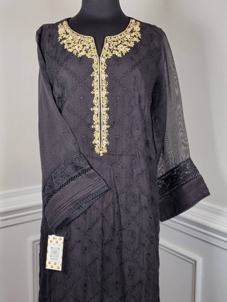 Black cotton net shirt with handwork on gala . Paired with raw silk pant.  Agha noor. Ready to wear.