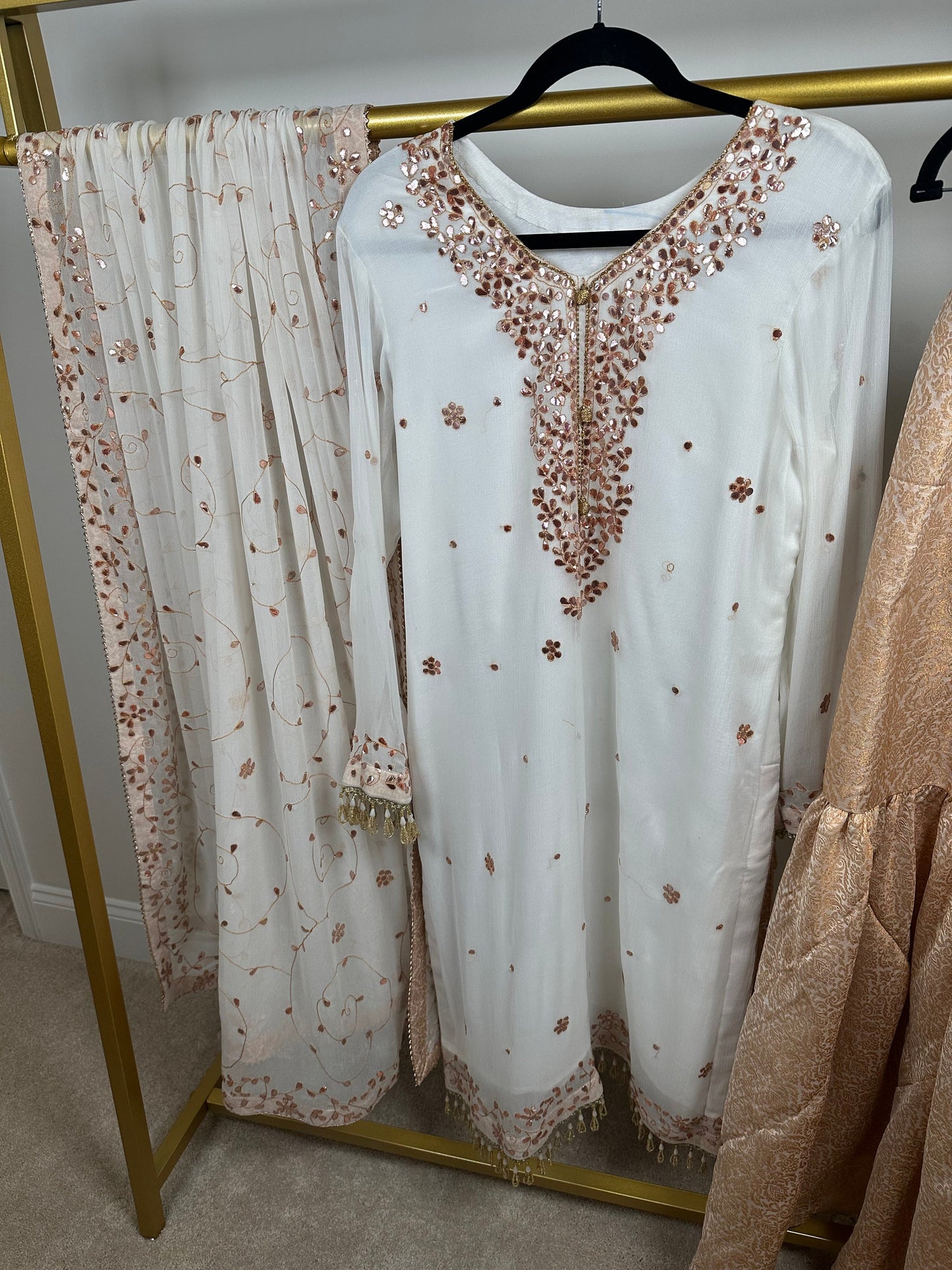 White chiffon shirt and duppata with heavy gota work. Paired with jamawar gharara.