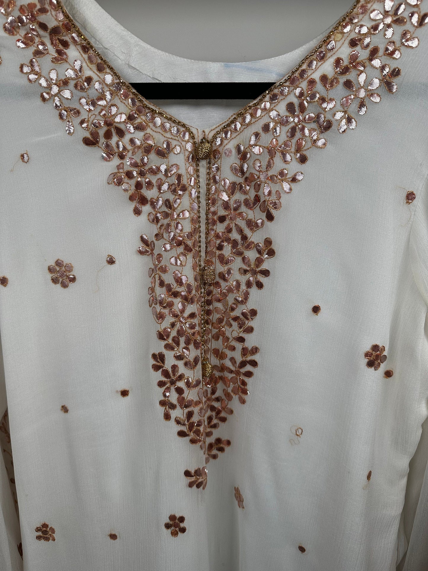 White chiffon shirt and duppata with heavy gota work. Paired with jamawar gharara.