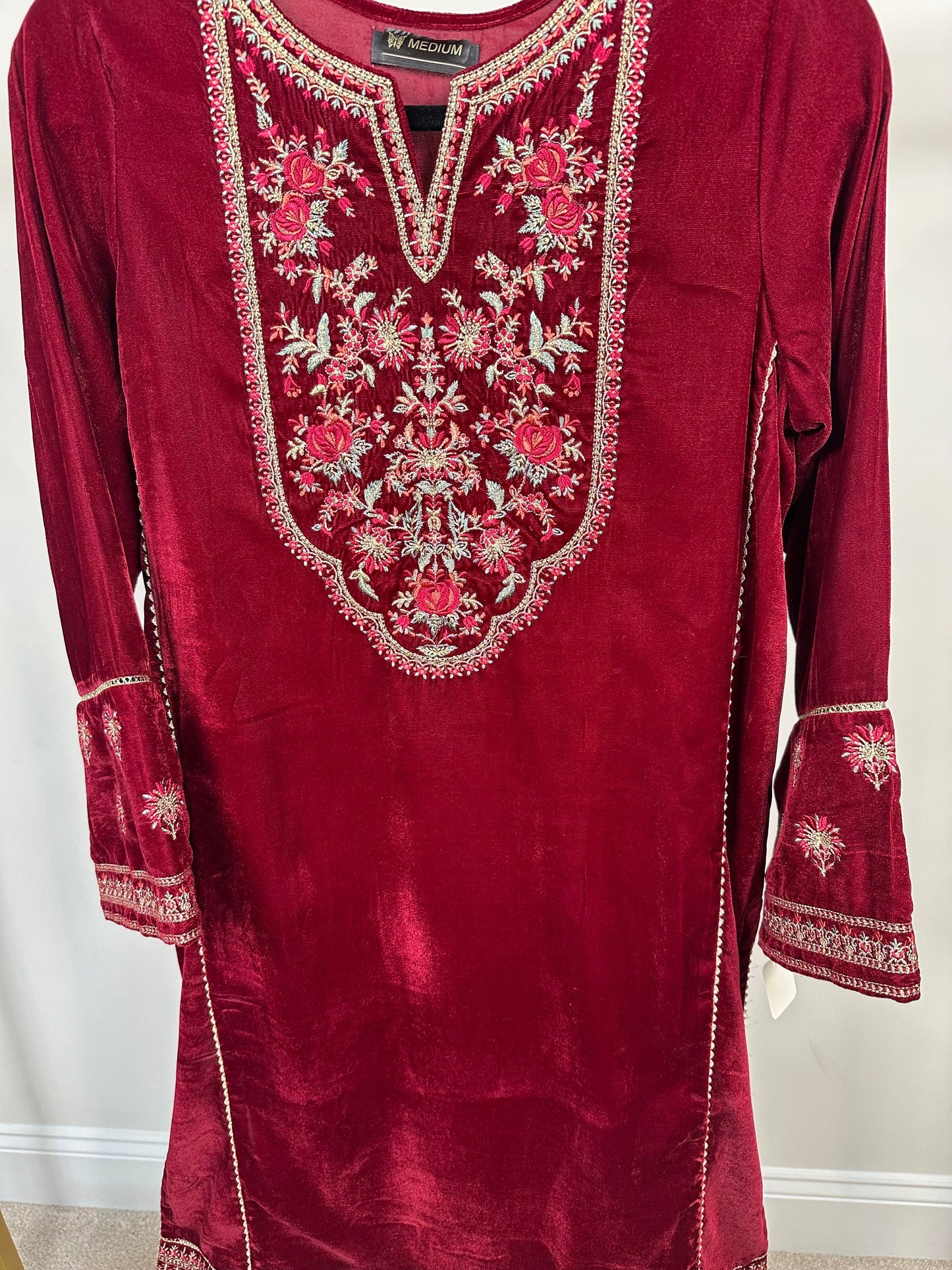 Maroon velvet kurti only with embroidery.