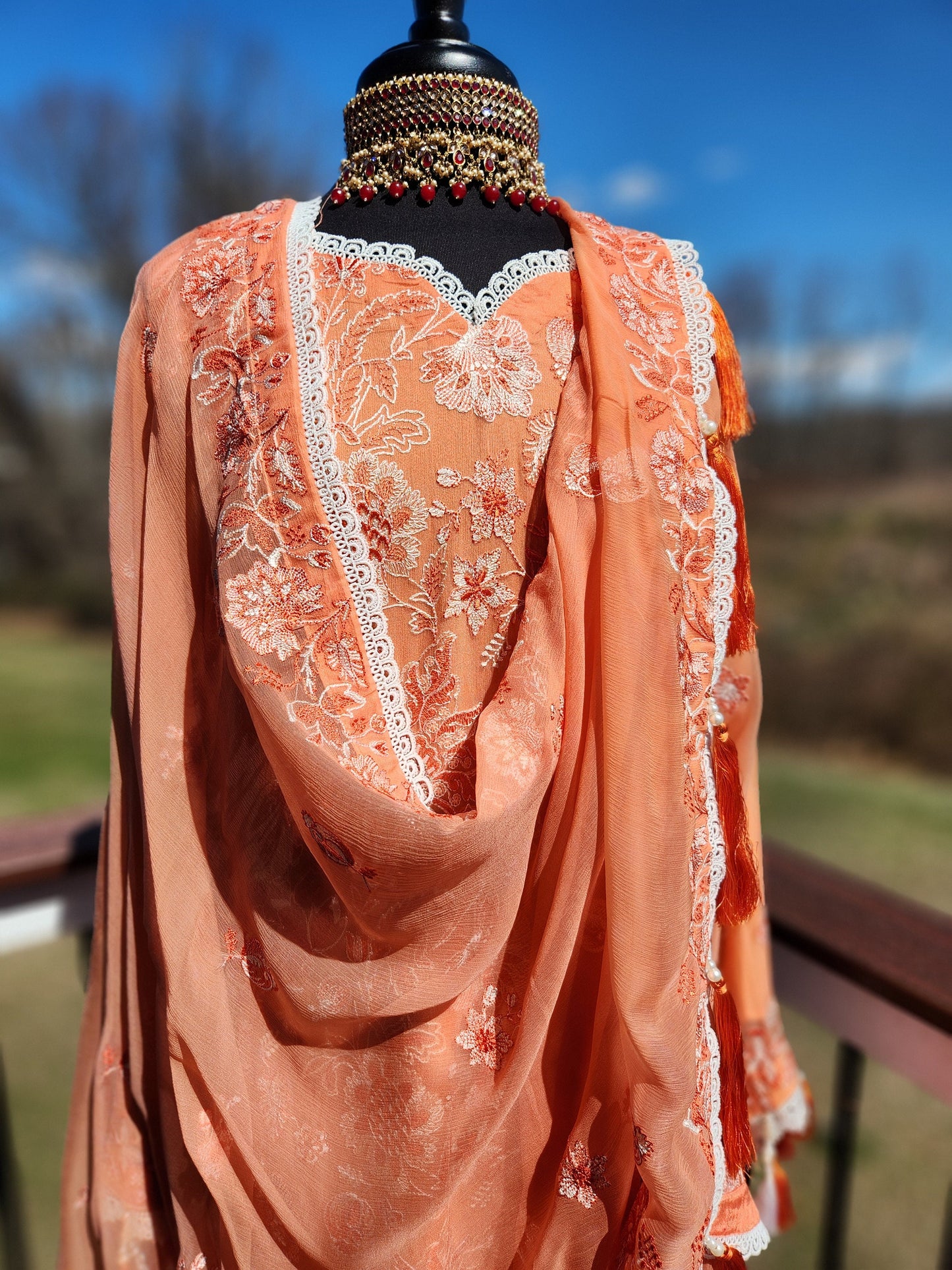 pure chiffon all over chikankari with orange and white thread.